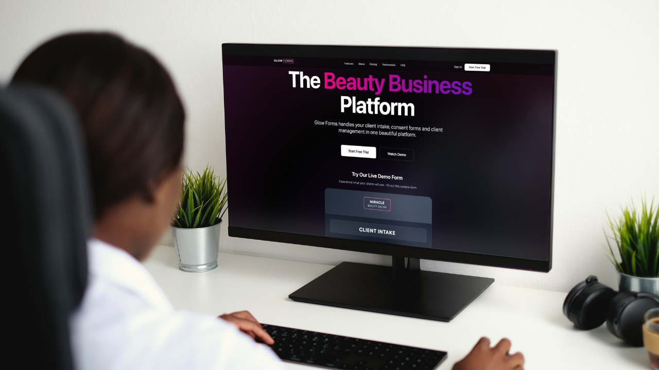 Salon manager viewing Glow Forms “Beauty Business Platform” on a desktop, opening the Client Intake form to manage searchable client records.