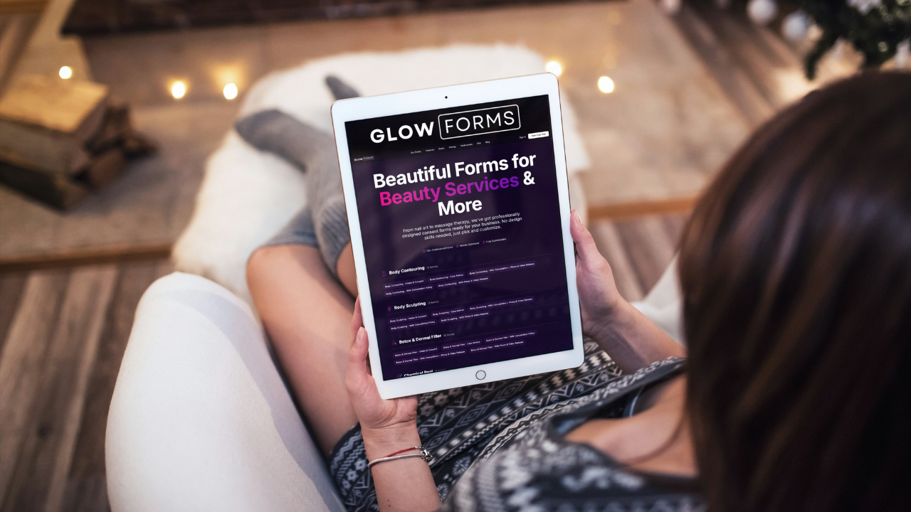 Client relaxing on a chair browsing Glow Forms beauty form templates on an iPad—selecting branded consent and intake forms.