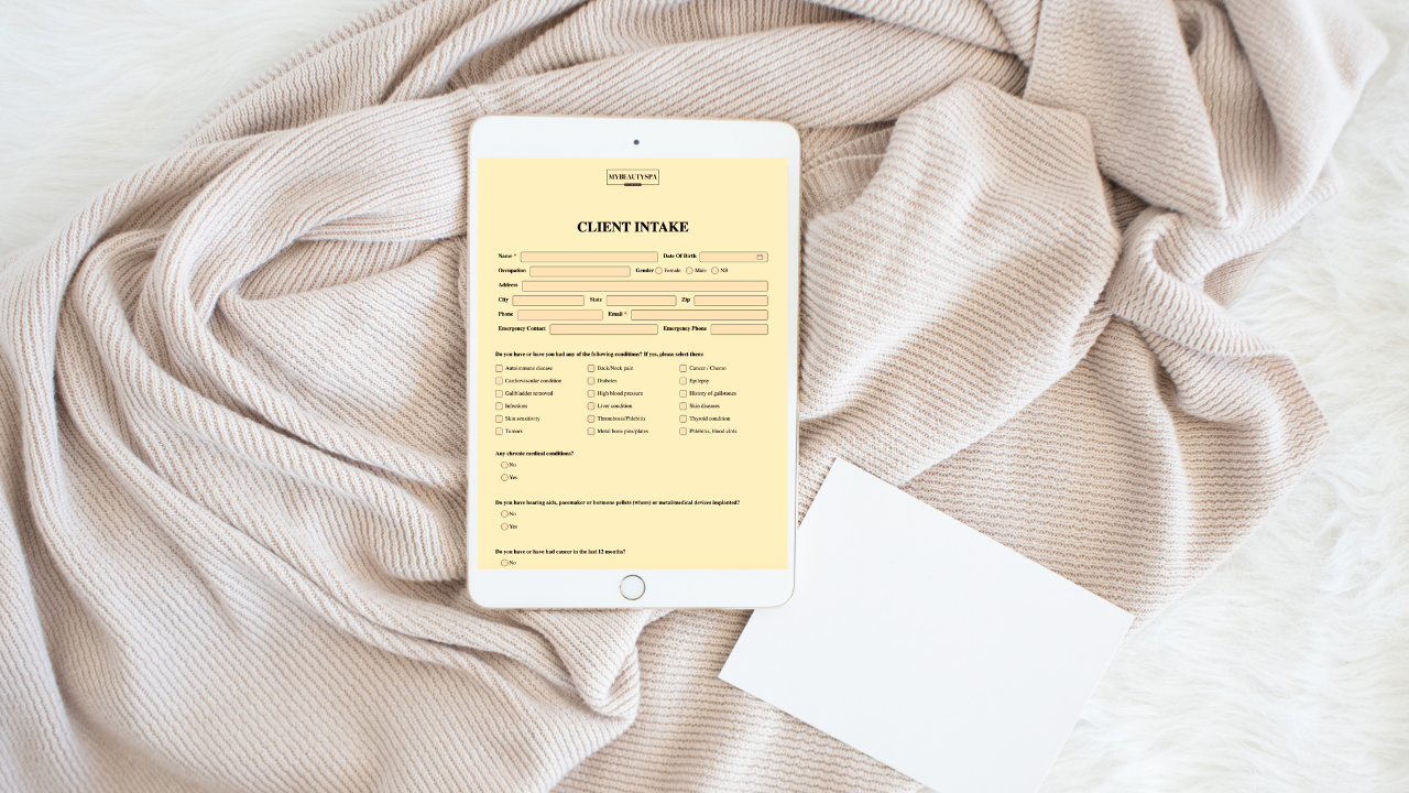 Digital client intake form on a tablet in a neutral spa setting.
