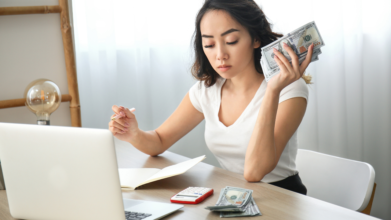 Beautician reviewing a service menu and drafting a price-change note at the front desk