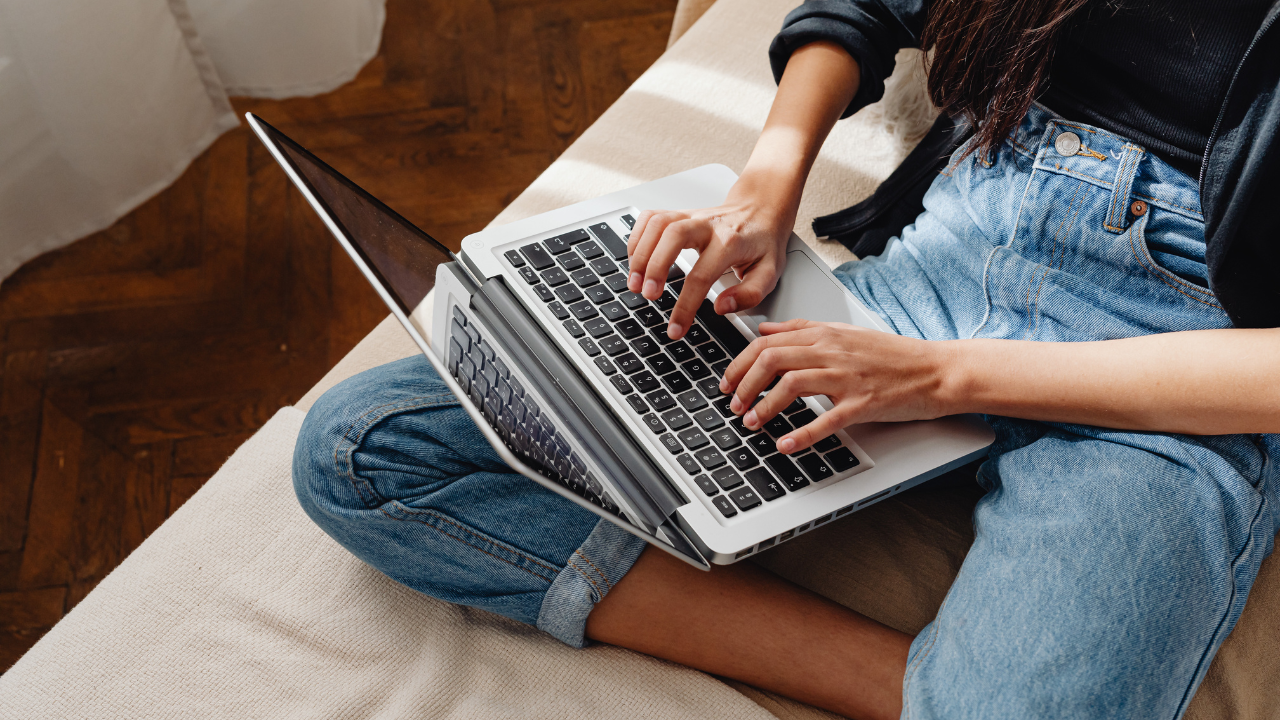 Salon owner updating a pricing page on a laptop with a tidy service menu nearby