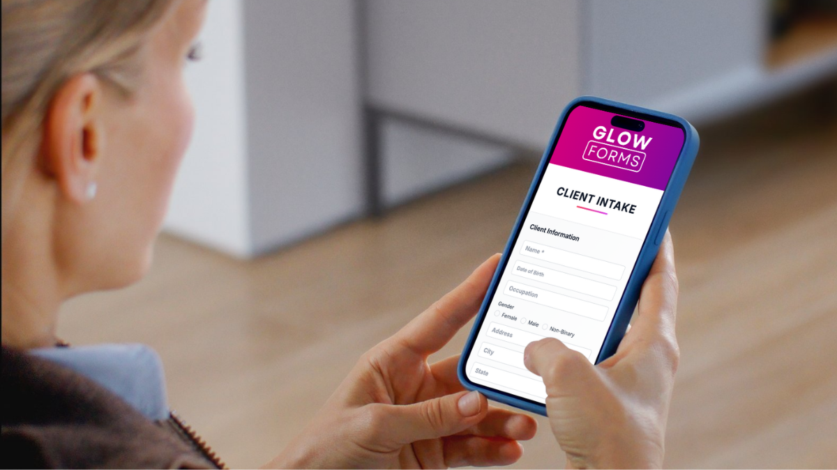 Client completing a GlowForms intake form on a phone before a beauty appointment